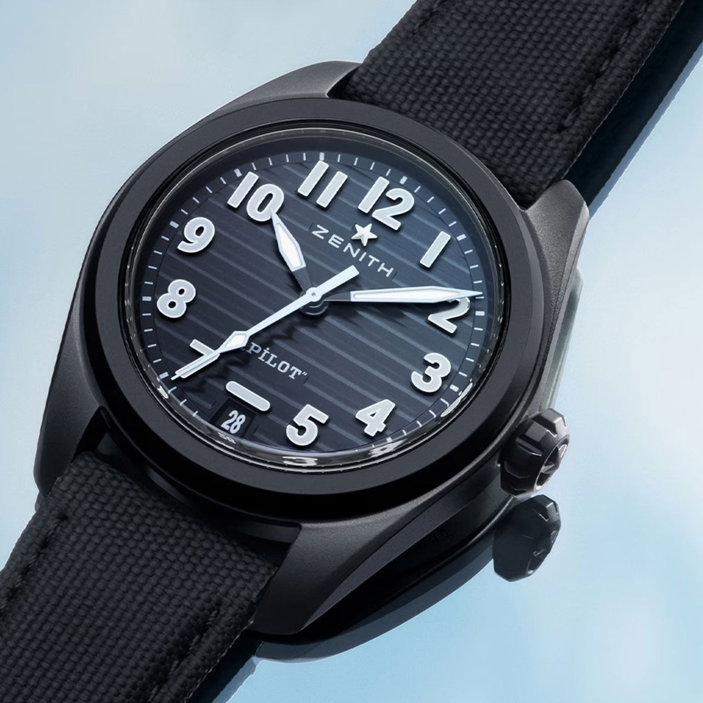 Black Zenith Pilot watch with a striped dial, white numerals, and black fabric strap.