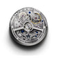 Zenith El Primero watch movement with intricate gears and a silver finish, featuring blue and gold details.