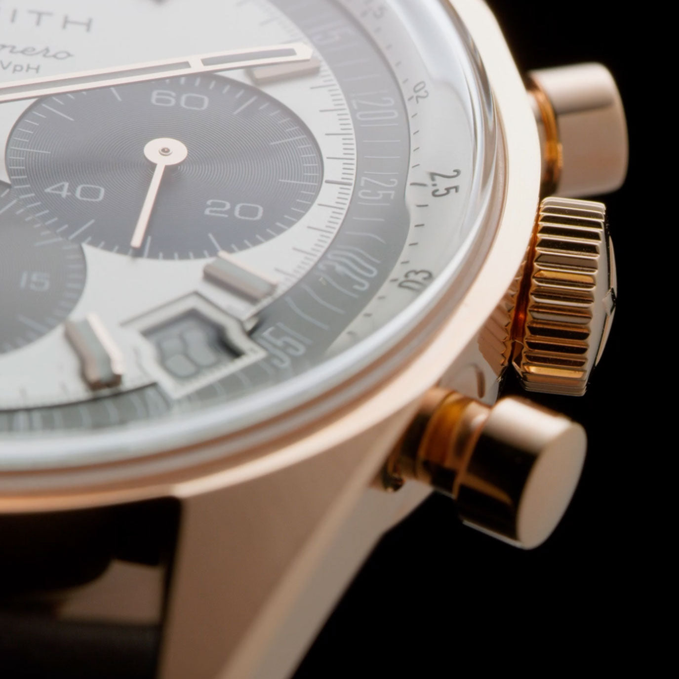 Close-up of a luxury chronograph watch with a rose gold case and black dial details.